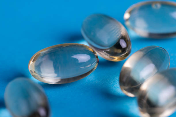 istock transparent fish oil capsules on blue paper 2177226856