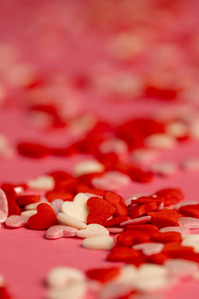 heart-shaped sugar candies are used to decorate cakes
