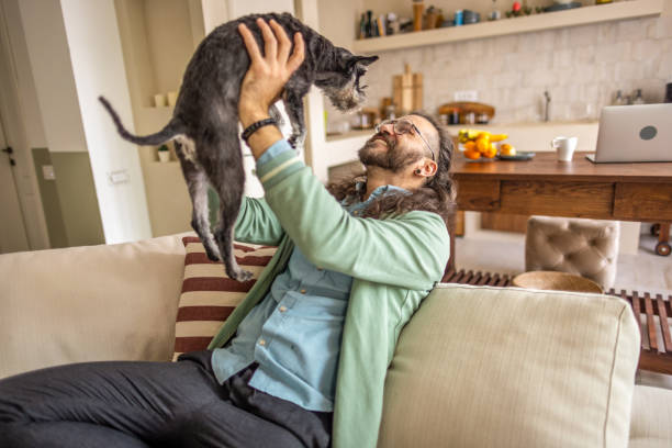 istock Men enjoys plays with his dog at home. 2177227631