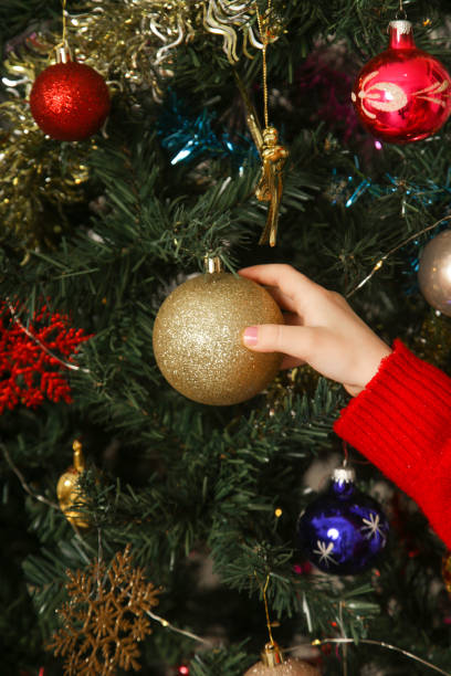 istock Decorating the tree, child hanging an ornament on the Christmas tree. 2177230535
