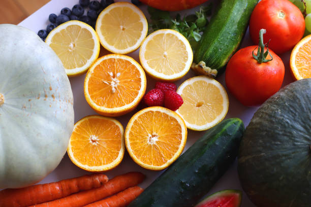 Various seasonal fruits and vegetables on white background. Summer and fall produce. Selective focus.