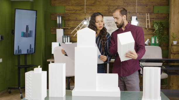 istock Woman and man architects talking about new project 2177233531