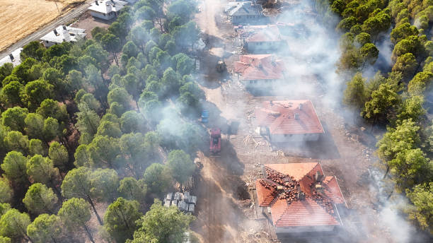 istock Smoke-Filled Air Over Houses in Forest Clearing 2177236022
