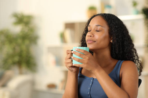 istock Relaxed black woman smelling coffee or tea at home 2177236783