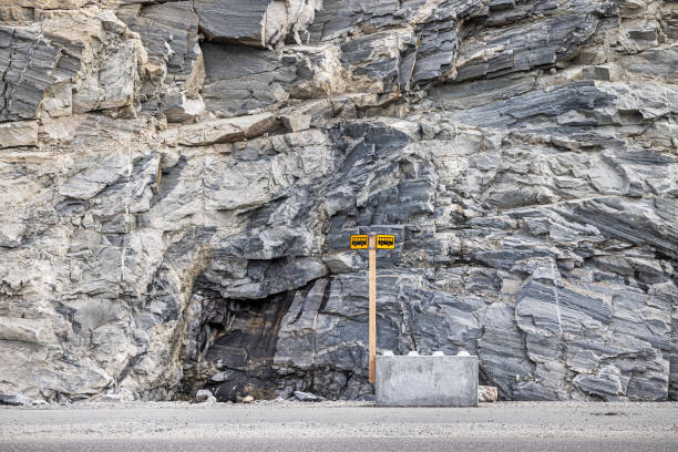Nuuk, Godthåb, Greenland, Denmark - August 21th 2024: Bus stop sign placed in front of a large rock