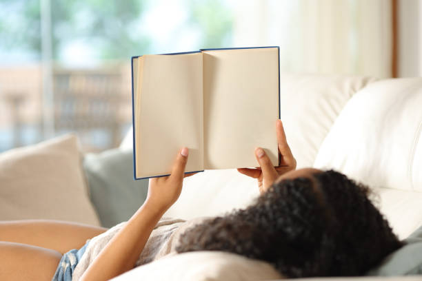 istock Black woman showing blank paper book pages 2177237064