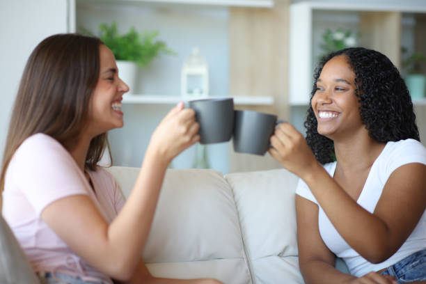 istock Happy interracial roommates toasting talking at home 2177237179