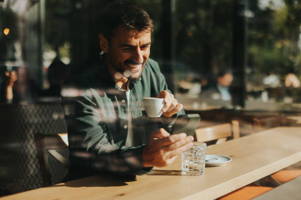 istock Toughtful man savoring coffee alone at a cozy cafe on a sunny day while lost in contemplation by the window 2177237948
