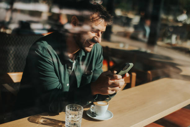 istock Toughtful man savoring coffee alone at a cozy cafe on a sunny day while lost in contemplation by the window 2177237949