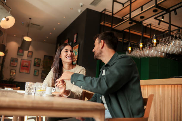 istock Joyful coffee conversation between friends in a cozy cafe surrounded by vibrant art on a sunny afternoon 2177238830