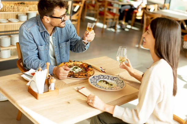 istock A cozy dinner date between two people enjoying drinks in a stylish restaurant atmosphere 2177238884