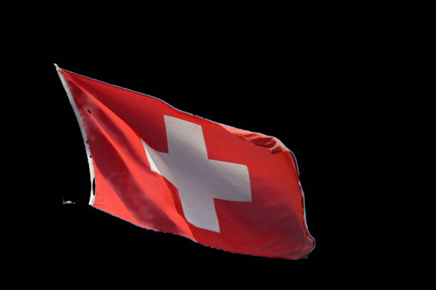 istock Swiss flag flying in the wind against blue sky 2177239908