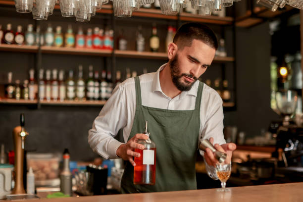 istock Skilled bartender prepares a cocktail at a stylish bar during a vibrant evening in a bustling city 2177240342