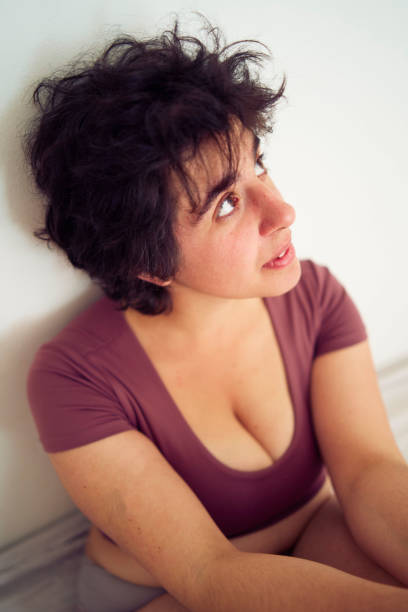 Pensive concerned  mature woman looking at the camera