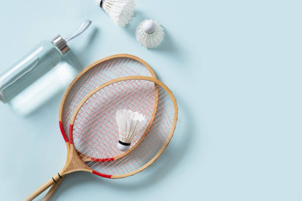 istock White badminton shuttlecock and two badminton rackets. Concept racket sport. 2177240917