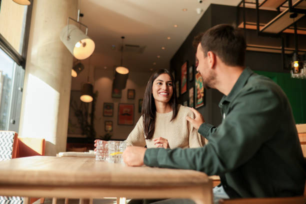 istock Joyful coffee conversation between friends in a cozy cafe surrounded by vibrant art on a sunny afternoon 2177243900