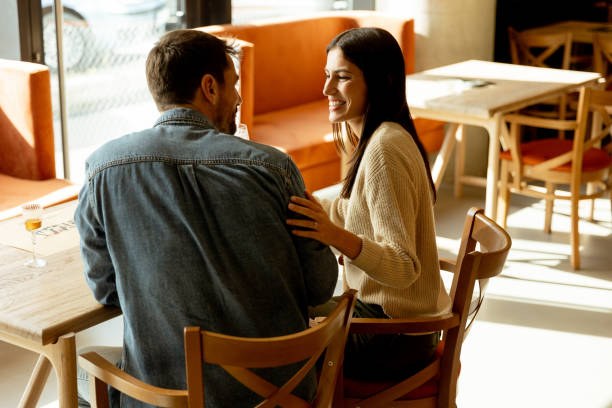 istock Couple enjoying refreshing drinks and laughter in a cozy cafe on a sunny afternoon 2177243922