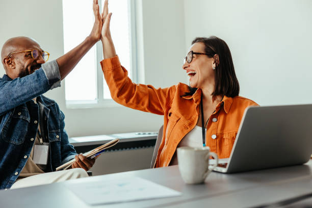 istock Team celebrating collaboration with a high-five in an office environment 2177244094