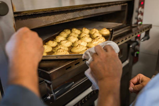 istock Baker Removing Freshly Baked Pastries From Oven 2177244470