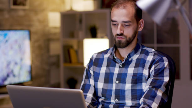 istock Male freelancer typing on laptop during night hours 2177247300