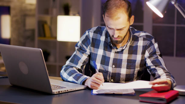 istock Caucasian businessman wearing a shirt while signing documents 2177247307