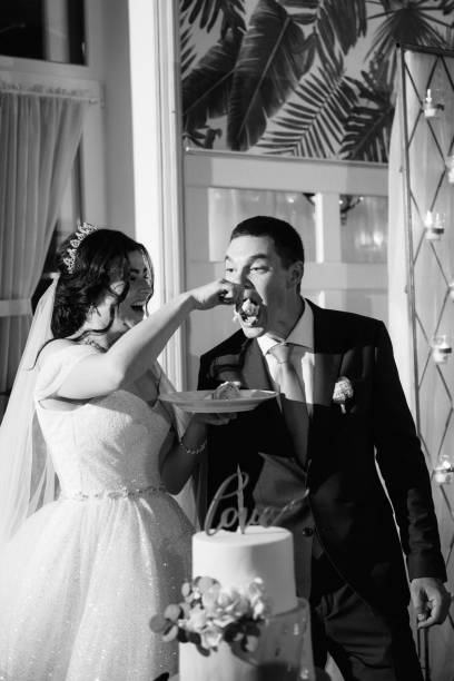 istock newlyweds happily cut and taste the wedding cake 2177247831