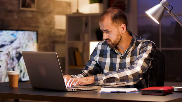 istock Businessman typing on laptop and searching through documents 2177247969