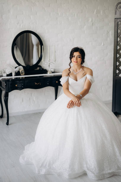 istock black-haired bride girl getting ready for groom in boudoir 2177254908