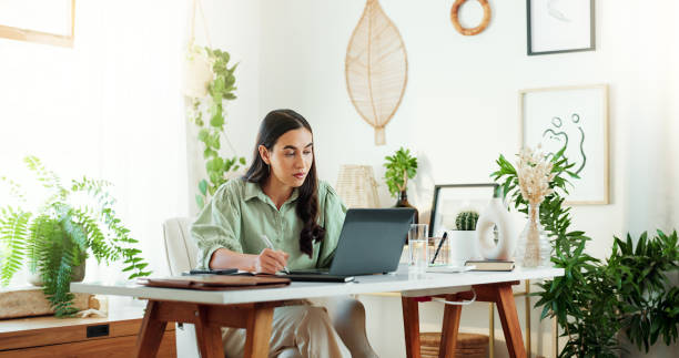 istock Research, notes and woman in home office with laptop, info and checking schedule for project ideas. Remote work, report and freelance writer at desk with computer, business planning or online article 2177259969