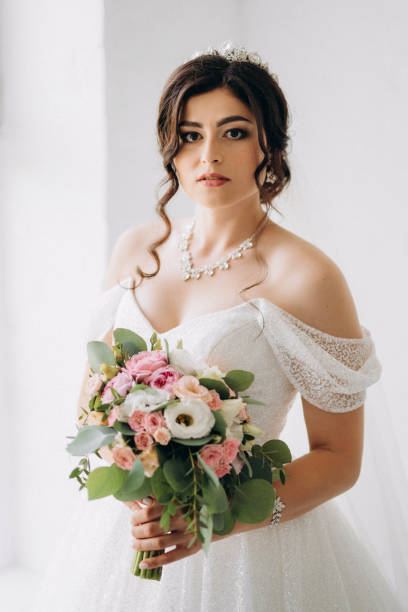 istock black-haired bride girl getting ready for groom in boudoir 2177261422