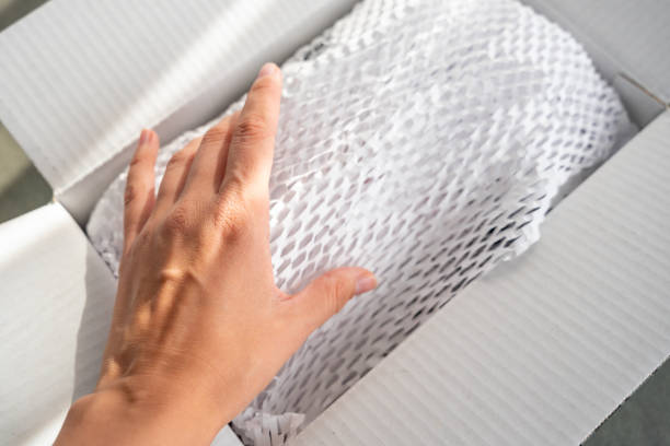 istock Corrugated white paper for safe transportation, in which the goods brought by the courier delivery service are wrapped, environmental packaging concept 2177262809