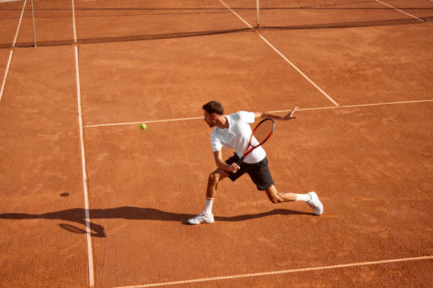 istock Young man, tennis player showing endurance and strength during intensive training on clay court. Man practicing for upcoming game 2177264062