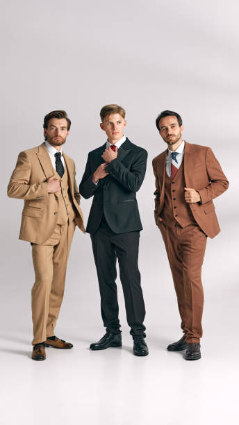 istock Elegant and professional group showcasing modern formal wear against white studio background. Each suit color complements diversity of styles. 2177264240
