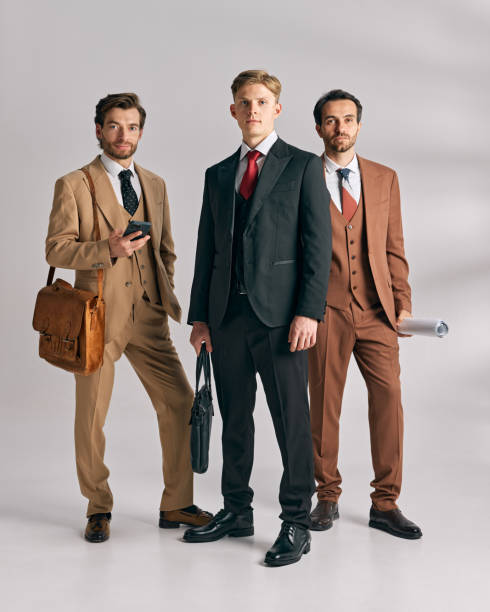 istock Professional team dressed in sleek, formal wear, looking determined and prepared for business challenges against white studio background. 2177264242