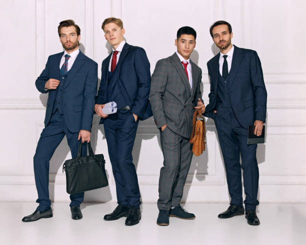 istock Formal group portrait, strong men presenting elegance and teamwork against white studio background. Businessmen ready for success. 2177264281