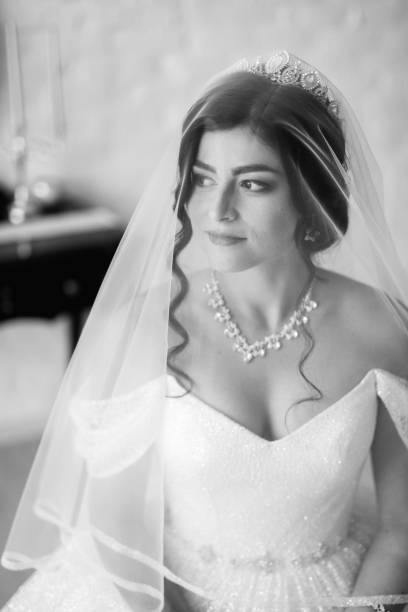 istock black-haired bride girl getting ready for groom in boudoir 2177266344