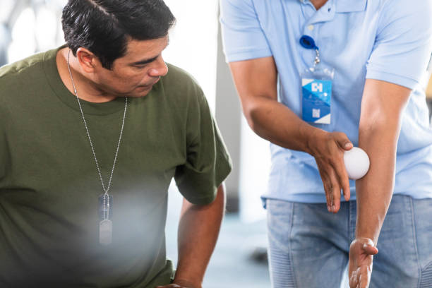 istock Male soldier learns how to use massage ball for arm 2177267708
