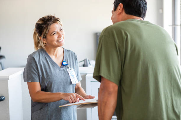 istock Female OT smiles while laying out treatment plan for man 2177267740