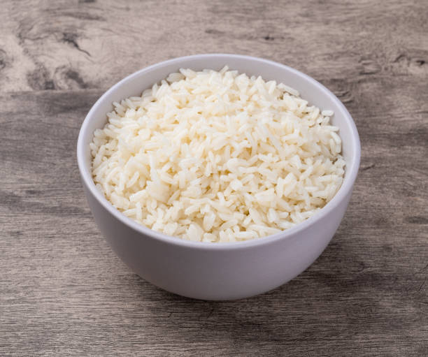 istock Cooked white rice in a bowl over wooden table 2177270229