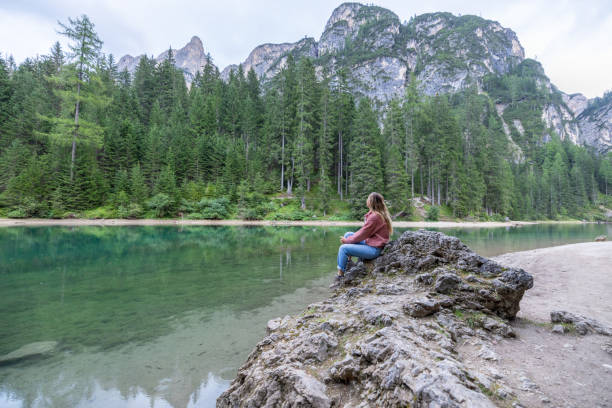 istock Woman Reflecting by Tranquil Mountain Lake 2177271796
