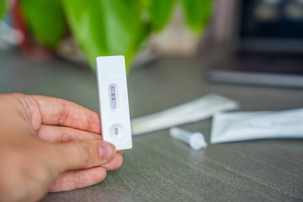 istock Rapid Antigen Test kit with with Positive result during swab COVID-19 testing. Coronavirus Self nasal or Home test, Autumn exacerbation of viruses 2177272973