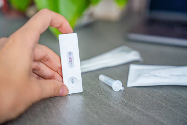 istock Rapid Antigen Test kit with with Positive result during swab COVID-19 testing. Coronavirus Self nasal or Home test, Autumn exacerbation of viruses 2177272981