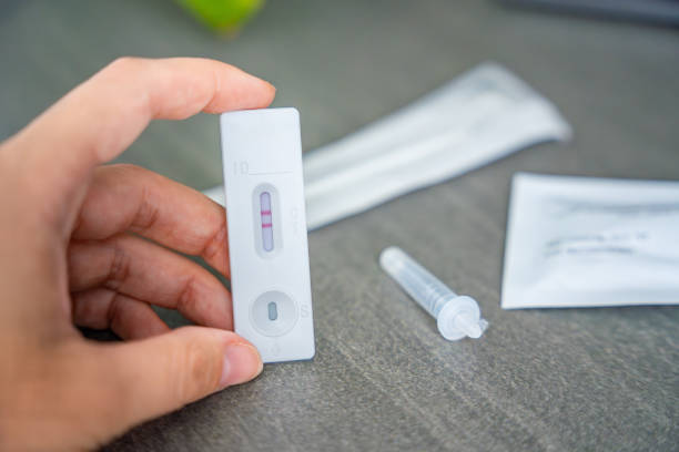 istock Rapid Antigen Test kit with with Positive result during swab COVID-19 testing. Coronavirus Self nasal or Home test, Autumn exacerbation of viruses 2177272986
