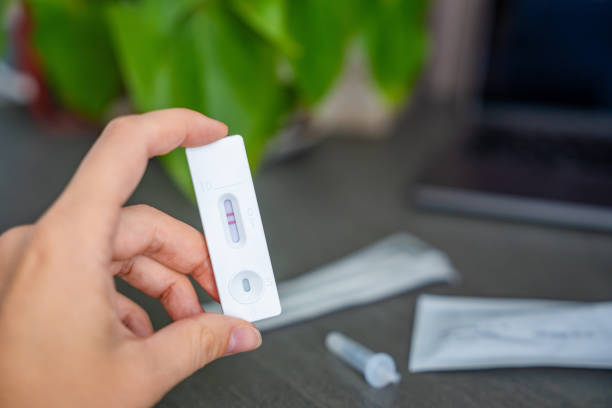 istock Rapid Antigen Test kit with with Positive result during swab COVID-19 testing. Coronavirus Self nasal or Home test, Autumn exacerbation of viruses 2177272988