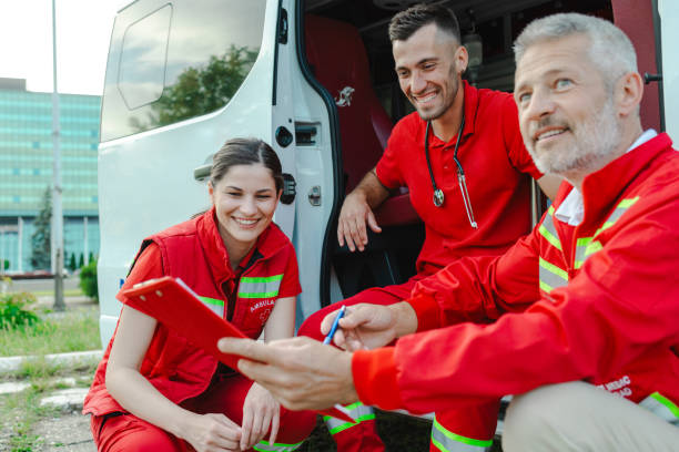 istock Paramedics discussing action plan beside emergency vehicle 2177274220