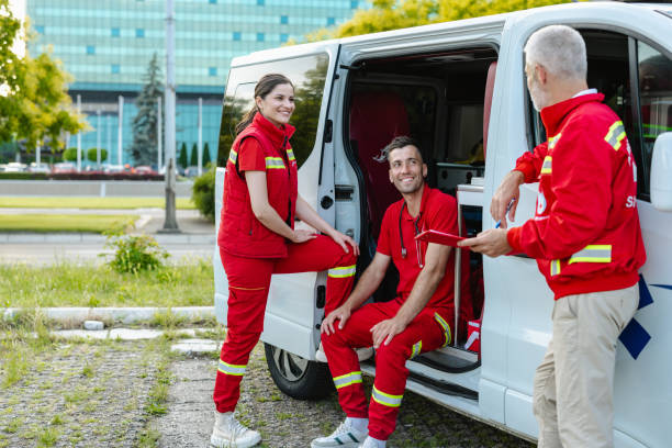istock Team of paramedics discussing by an ambulance van 2177274632