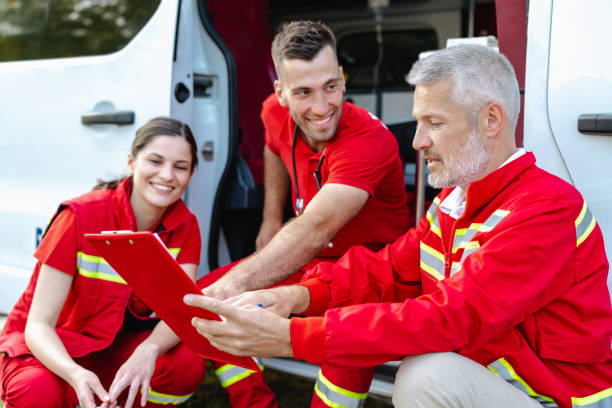 istock Emergency medical team discussing plans by an ambulance 2177274846