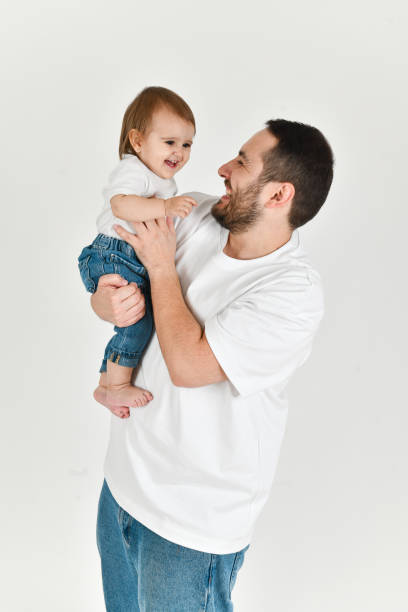 istock Little Daughter Playing With Father's Beard While He's Holding and Embracing Her Both Laughing 2177276386