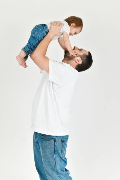 istock Father Holding His Daughter in Air While She's Laughing and Playing With His Beard 2177277147