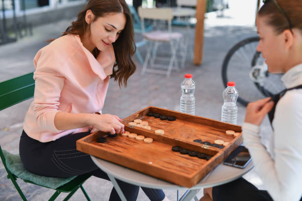 istock Young Joyful Female Focused Down on Board Game Planning Next Move 2177277737